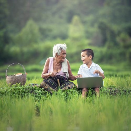 Old lady speaking with a child in a field